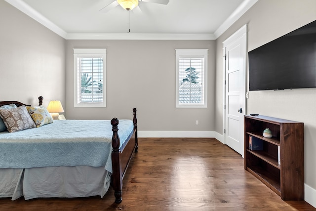 bedroom with ornamental molding, dark hardwood / wood-style floors, and ceiling fan