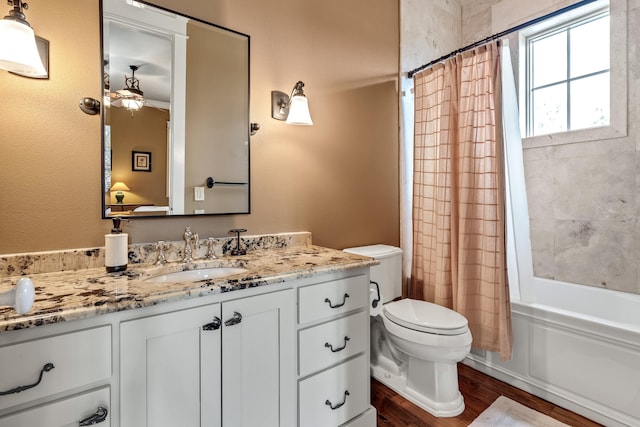 full bathroom featuring vanity, shower / tub combo, hardwood / wood-style flooring, and toilet