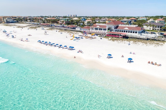 bird's eye view with a water view and a beach view