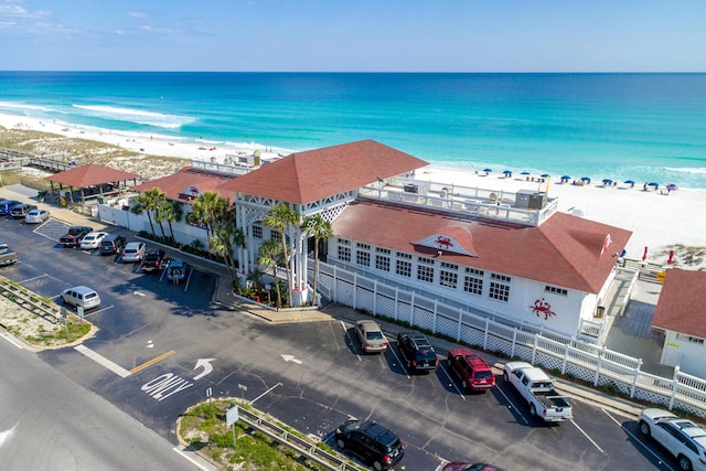 drone / aerial view with a beach view and a water view