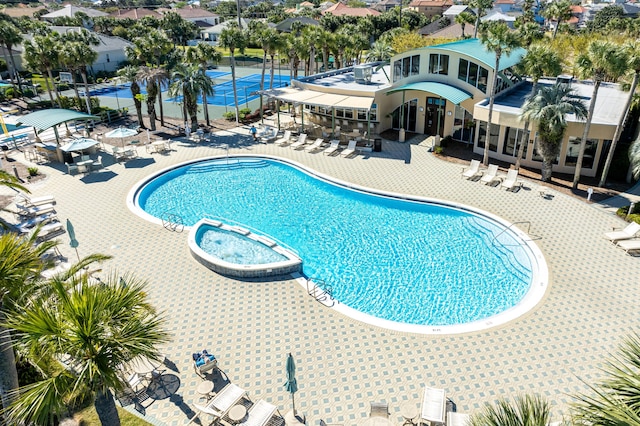 view of pool with a hot tub and a patio