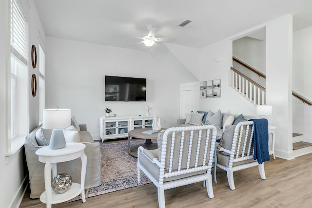 living room featuring hardwood / wood-style floors and ceiling fan