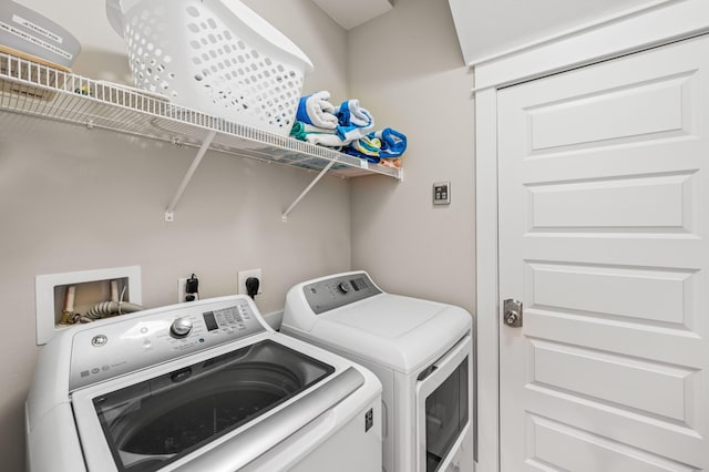 washroom featuring washer and dryer