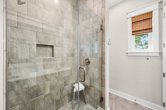 bathroom with tile patterned flooring and a shower with shower door