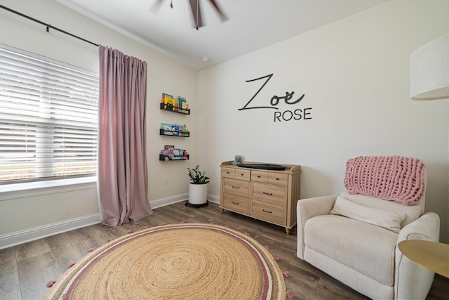 living area featuring a ceiling fan, wood finished floors, and baseboards