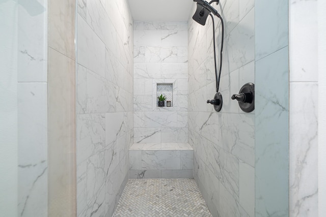 bathroom with tiled shower