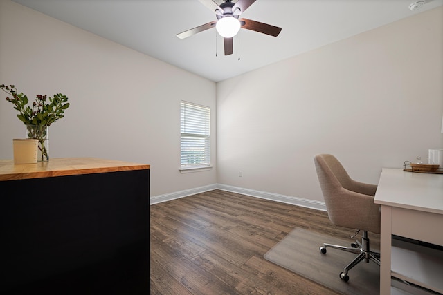 office space featuring ceiling fan, baseboards, and wood finished floors