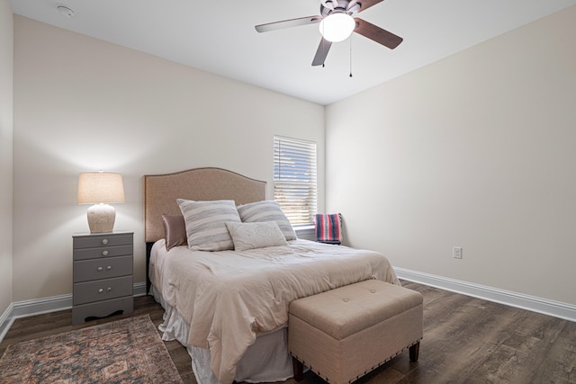 bedroom with a ceiling fan, baseboards, and dark wood-style flooring