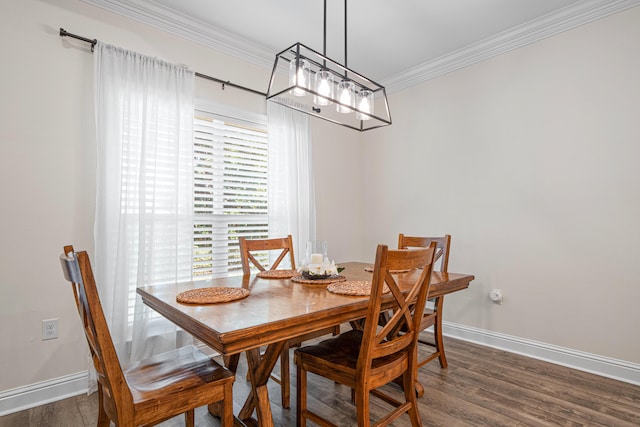 dining area with crown molding, baseboards, and dark wood-style flooring