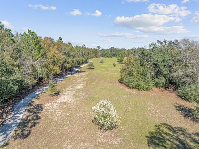 drone / aerial view featuring a forest view