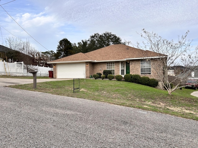 ranch-style house with a garage and a front yard