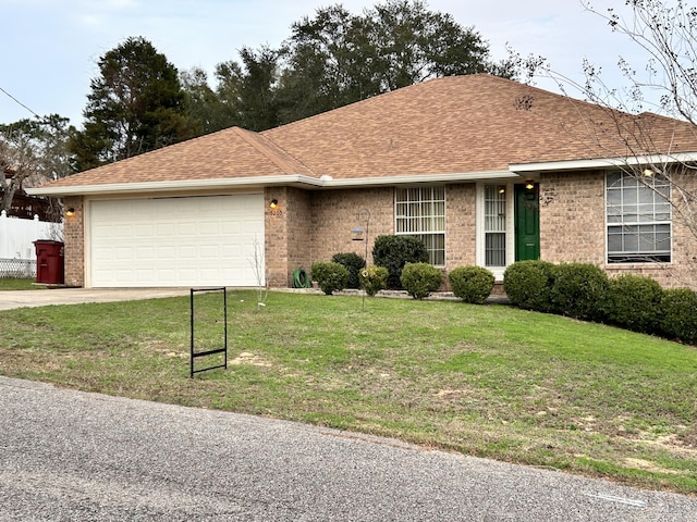 ranch-style home with a garage and a front lawn