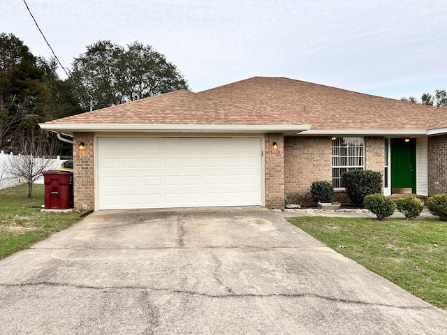 ranch-style home featuring a garage and a front lawn