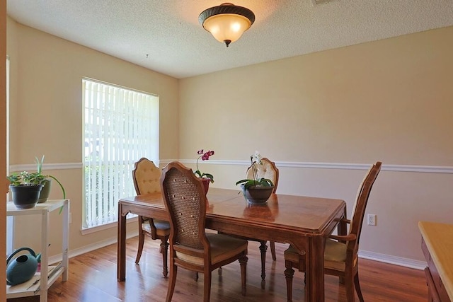 5205 Whitehurst Ln, Crestview, FL 32536 - dining room featuring plenty of natural light, wood finished floors, a textured ceiling, and baseboards