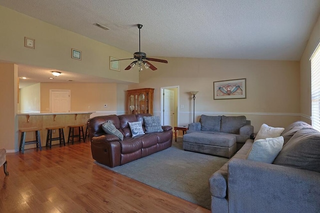5205 Whitehurst Ln, Crestview, FL 32536 - living room with ceiling fan, wood finished floors, a textured ceiling, and high vaulted ceiling