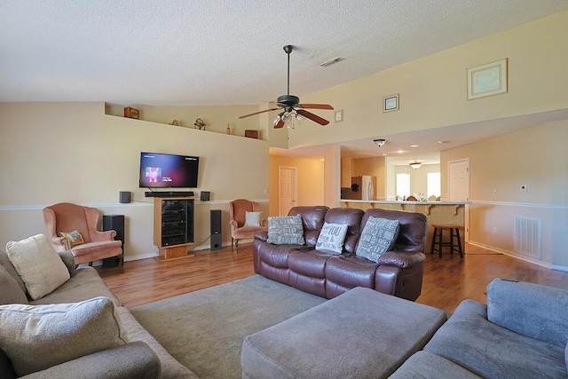 5205 Whitehurst Ln, Crestview, FL 32536 - living area featuring wood finished floors, ceiling fan, a textured ceiling, and high vaulted ceiling