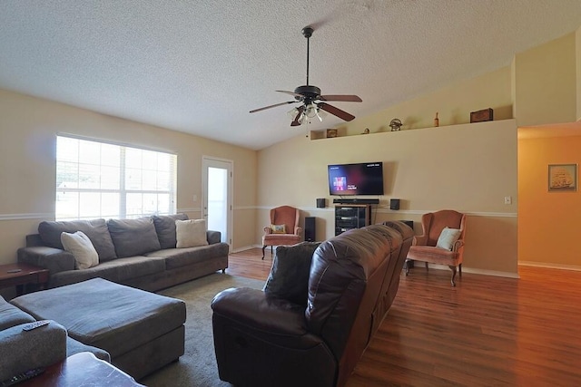 5205 Whitehurst Ln, Crestview, FL 32536 - living area with a textured ceiling, wood finished floors, lofted ceiling, ceiling fan, and baseboards
