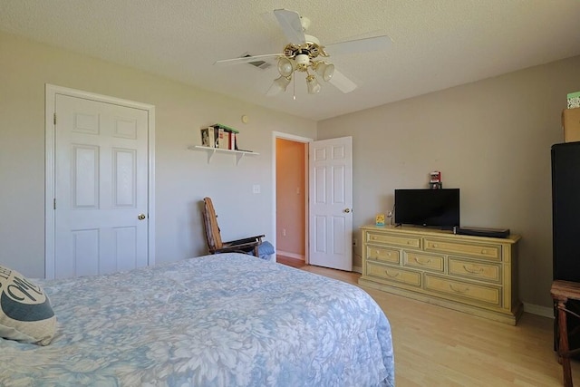 5205 Whitehurst Ln, Crestview, FL 32536 - bedroom featuring light wood-style floors, a ceiling fan, a textured ceiling, and baseboards