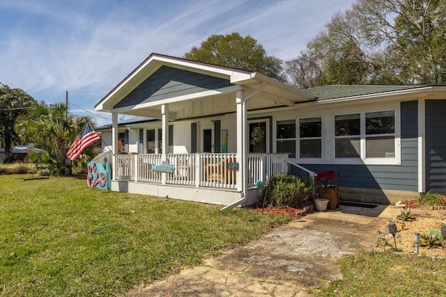 exterior space featuring covered porch and a lawn