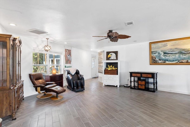 living area with a ceiling fan, recessed lighting, visible vents, and wood finished floors