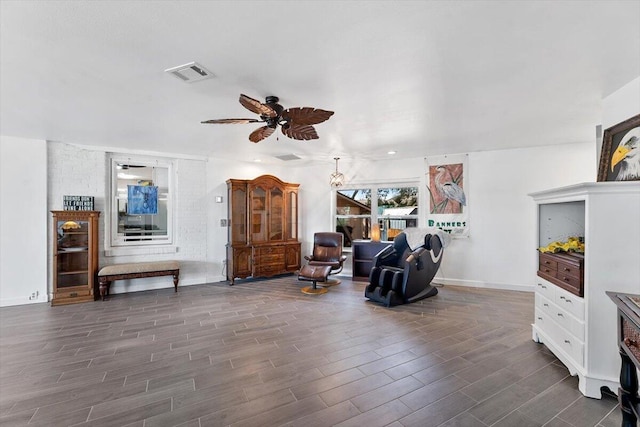 sitting room featuring visible vents, ceiling fan, and wood finished floors