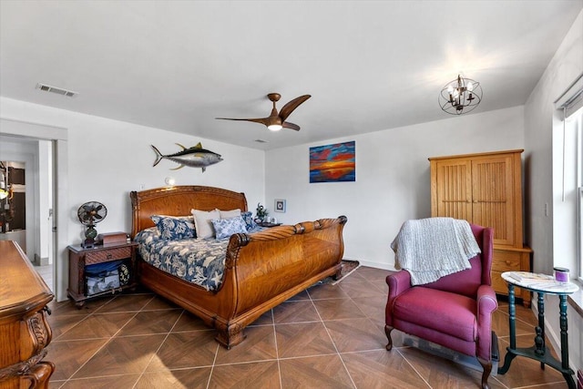 bedroom with baseboards, visible vents, and ceiling fan with notable chandelier