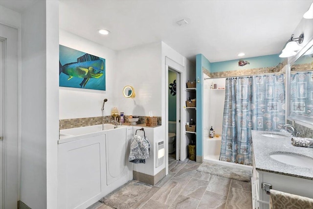 full bathroom featuring a garden tub, a sink, a shower stall, and toilet