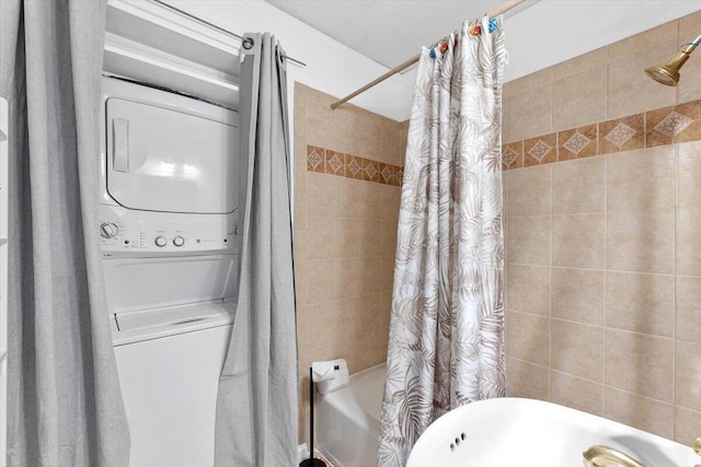 bathroom with shower / bath combination with curtain and stacked washer / drying machine