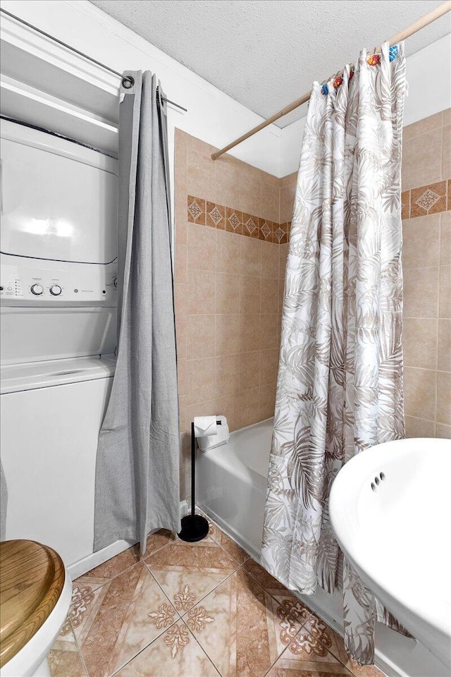 full bathroom featuring shower / bathtub combination with curtain, tile patterned flooring, and a textured ceiling