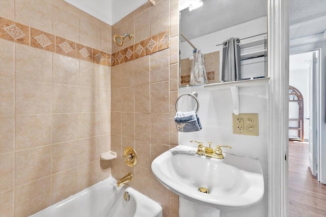 bathroom with a sink and shower / tub combo with curtain