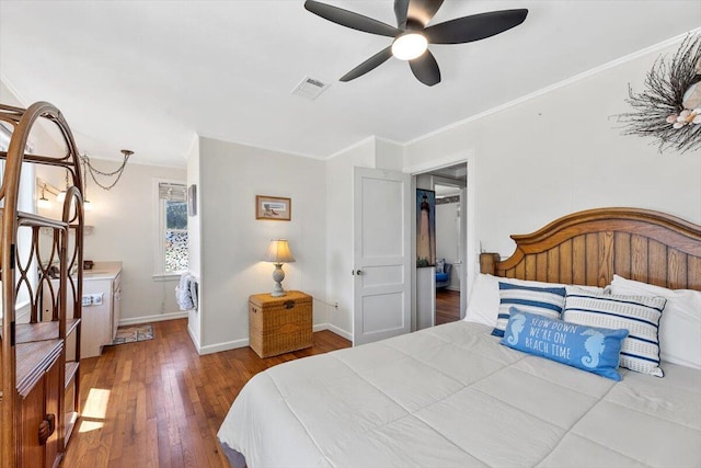 bedroom with ceiling fan, wood finished floors, visible vents, baseboards, and ornamental molding