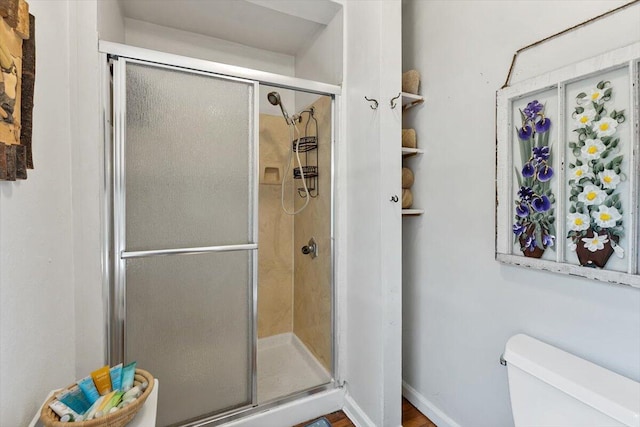 full bathroom with a stall shower and toilet