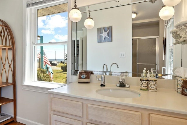 full bathroom with a shower stall and vanity