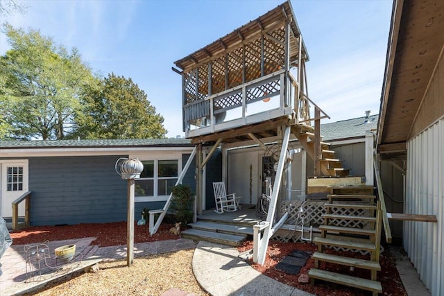 rear view of property with stairway