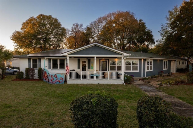 view of front of house with a front lawn and a porch