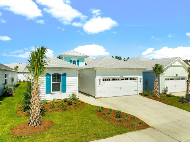 single story home with a garage and a front lawn