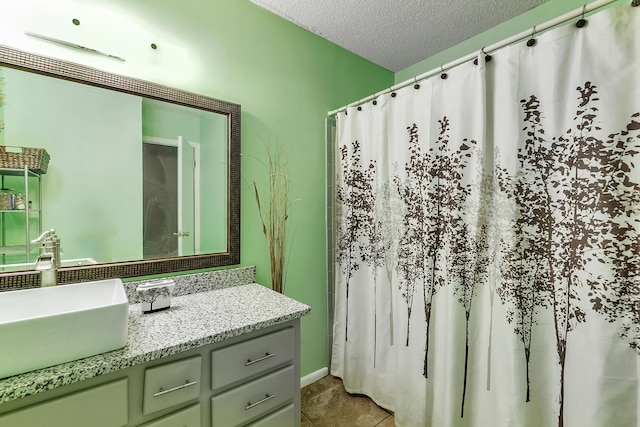 bathroom with a shower with shower curtain, tile patterned floors, a textured ceiling, and vanity