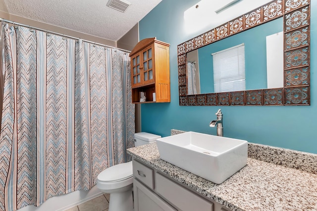 full bathroom with visible vents, toilet, tile patterned floors, a textured ceiling, and vanity