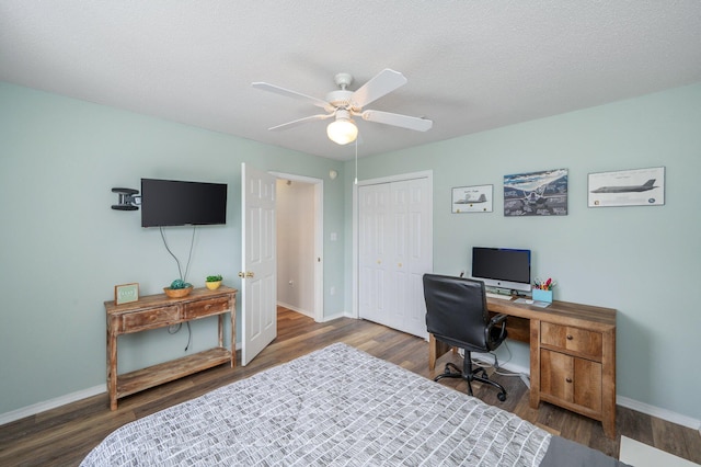 home office with ceiling fan, a textured ceiling, and dark hardwood / wood-style flooring