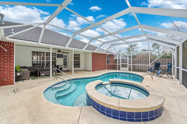 view of pool featuring a lanai, a patio area, and an in ground hot tub