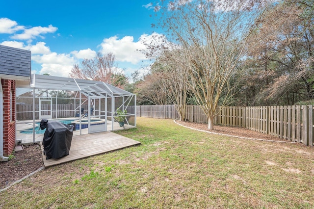 view of yard with a swimming pool side deck and glass enclosure