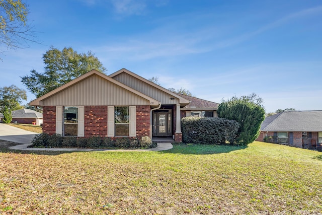 view of front of property with a front lawn and brick siding