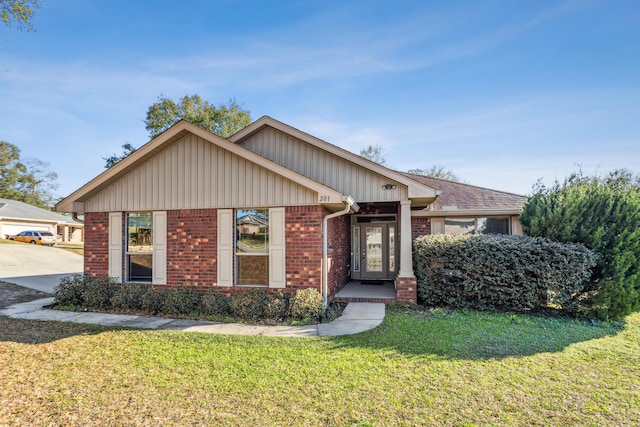 view of front of house with brick siding and a front lawn