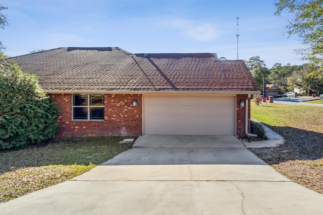 ranch-style home with an attached garage, a front lawn, concrete driveway, and brick siding