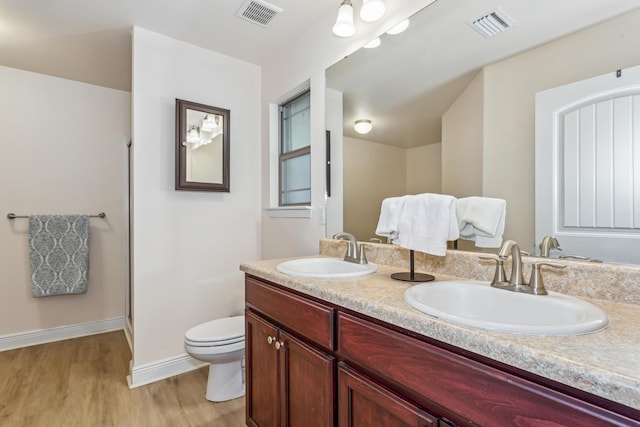 bathroom featuring visible vents, a sink, and toilet