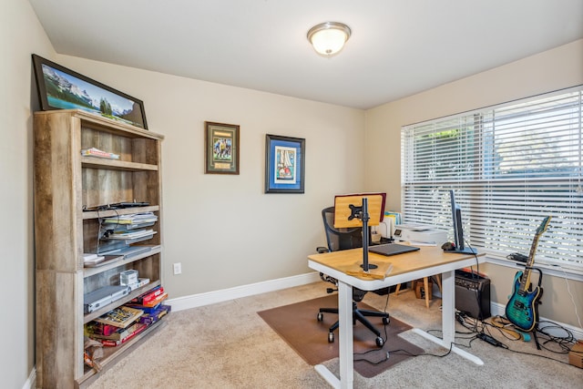 carpeted home office with plenty of natural light and baseboards