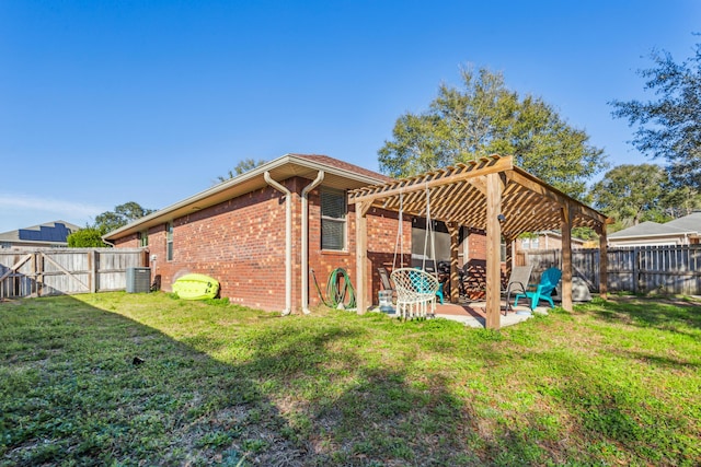 back of house with brick siding, a yard, a patio, central air condition unit, and a pergola