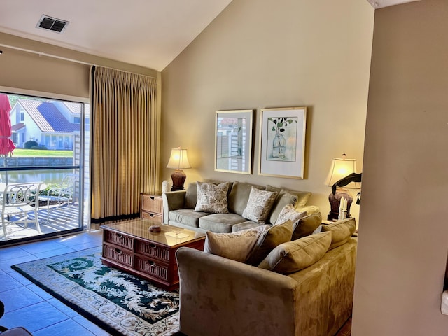 living room featuring lofted ceiling and tile patterned floors