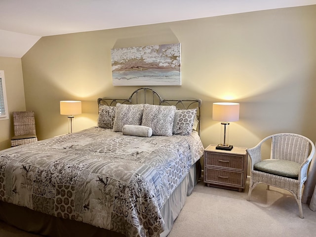 carpeted bedroom with lofted ceiling