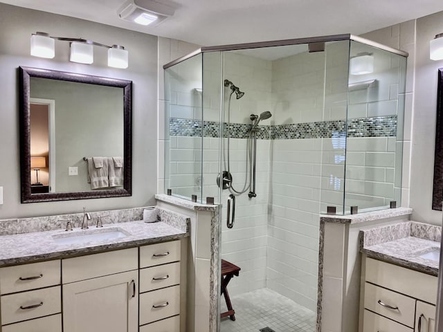 bathroom featuring walk in shower and vanity